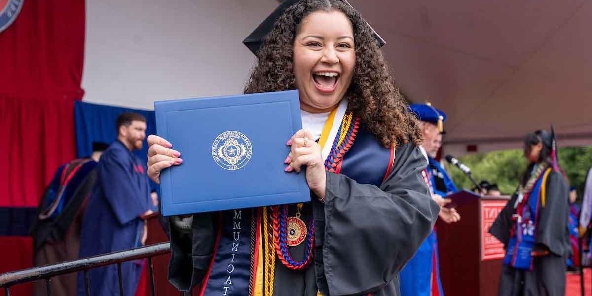 Saint mary's college graduate holding her diploma